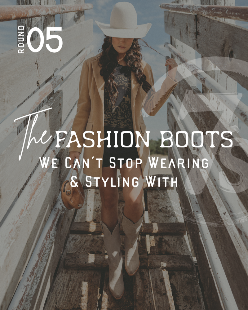 A woman in a tan blazer, graphic t-shirt, cowboy hat, and white cowgirl boots walks on a rustic wooden bridge. Overlaid text reads: The Fashion Boots We Can’t Stop Wearing & Styling With. Round 05—perfect for that iconic western-inspired look.