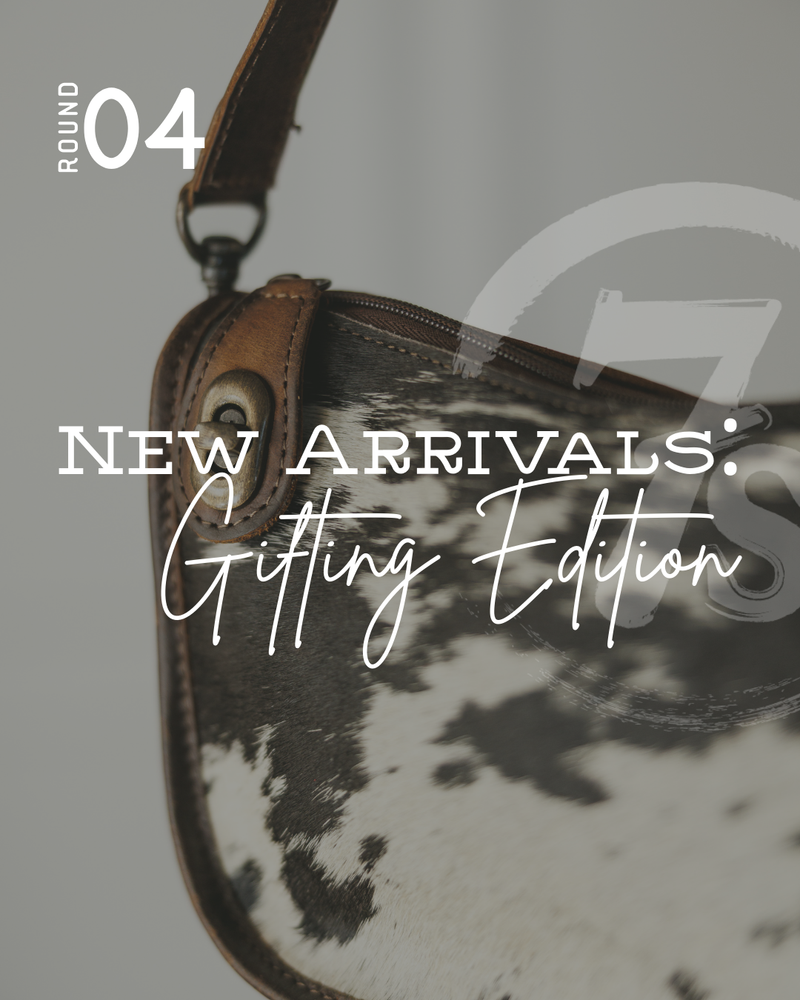 A close-up of a cowhide handbag with a brown strap. Overlaid text reads “Round 04. New Arrivals: Gifting Edition.” The bag’s khaki undertones complement the neutral, soft-focused background.