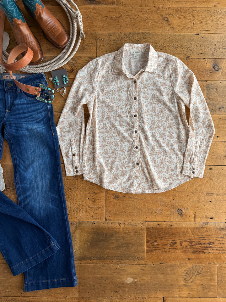 The Nekoma by Savannah Sevens western life{&}style is a long sleeve button up cream paisley shirt styled with blue jeans, a brown tooled leather belt, turquoise jewelry, and cowboy boots for a classic Western look.
