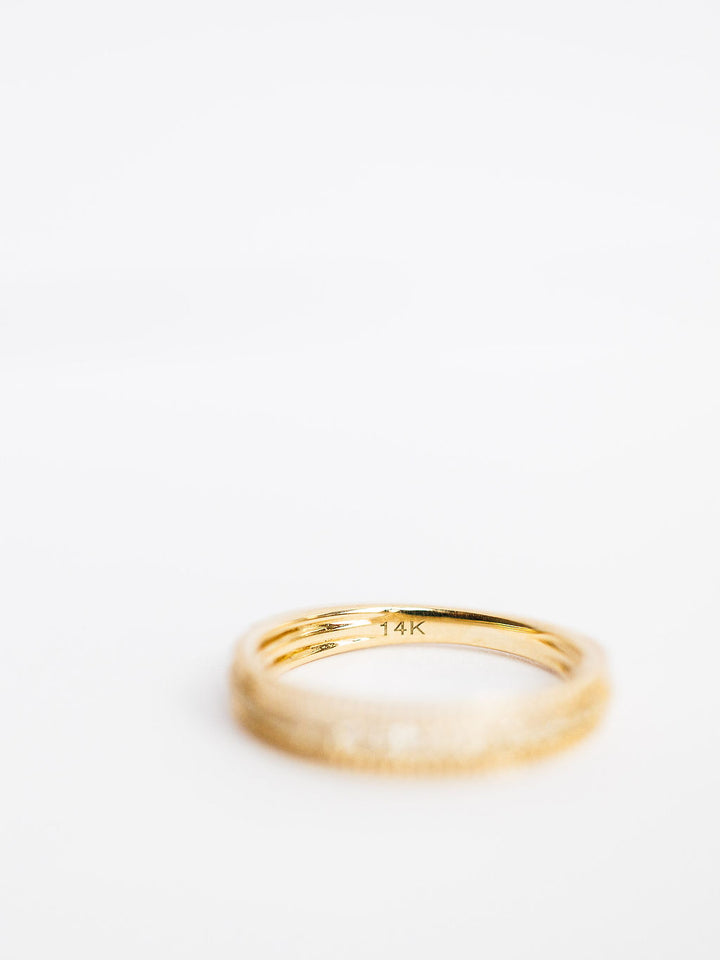 The Diamond Milgrain Ring by Savannah Sevens western life{&}style is shown against a plain white background. This 14K gold ring features elegant milgrain detailing and has "14K" engraved on the inside. Collaboration the Devereaux Gold.