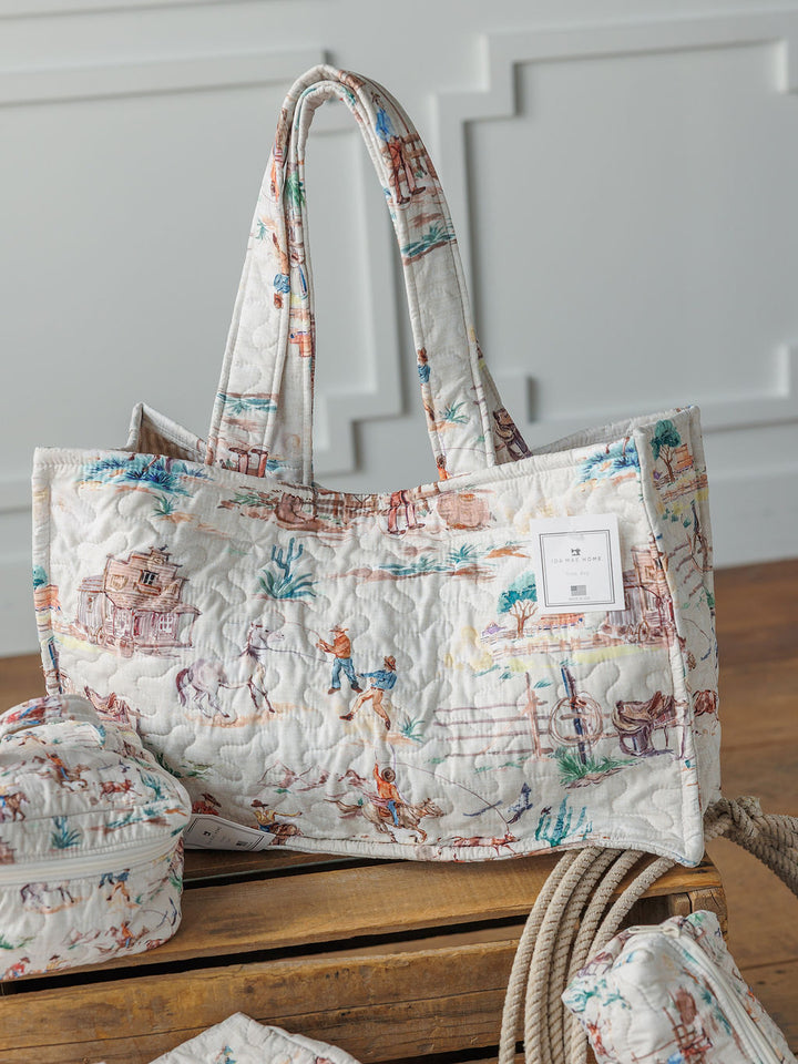 The Retro Cowboy Collection by Savannah Sevens western life{&}style features a handmade quilted tote with padded handles, colorful countryside illustrations, with matching pouches.