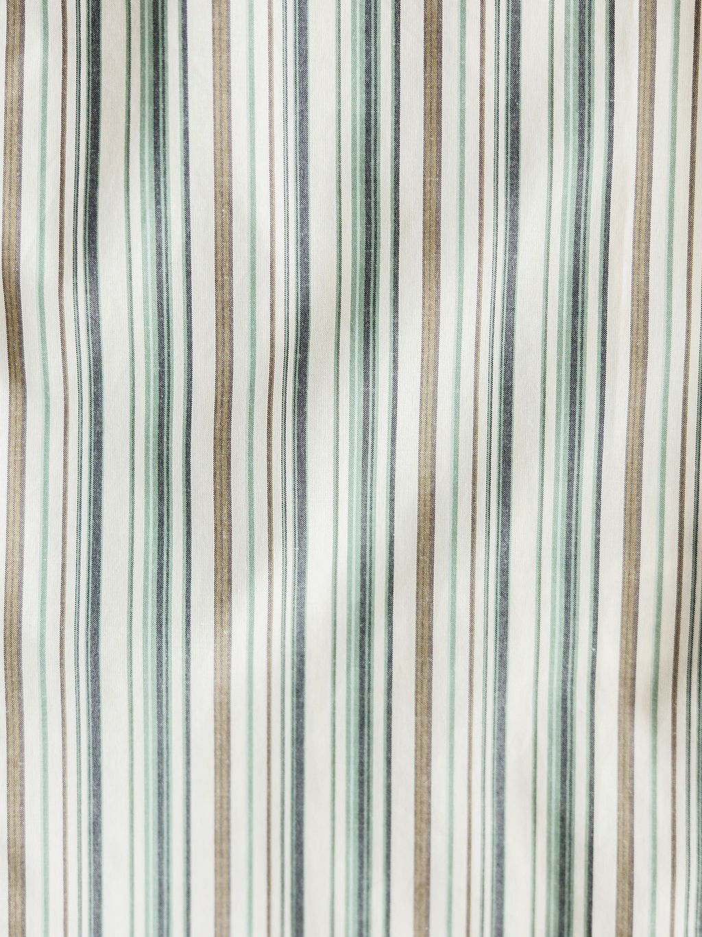 Close-up of The Austwell Men's shirt by Savannah Sevens western life&style, featuring vertical stripes in green, grey, beige, and white with varying thicknesses on a slightly wrinkled fabric.