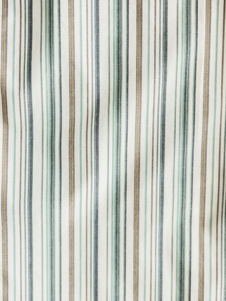 Close-up of The Austwell Men's shirt by Savannah Sevens western life&style, featuring vertical stripes in green, grey, beige, and white with varying thicknesses on a slightly wrinkled fabric.