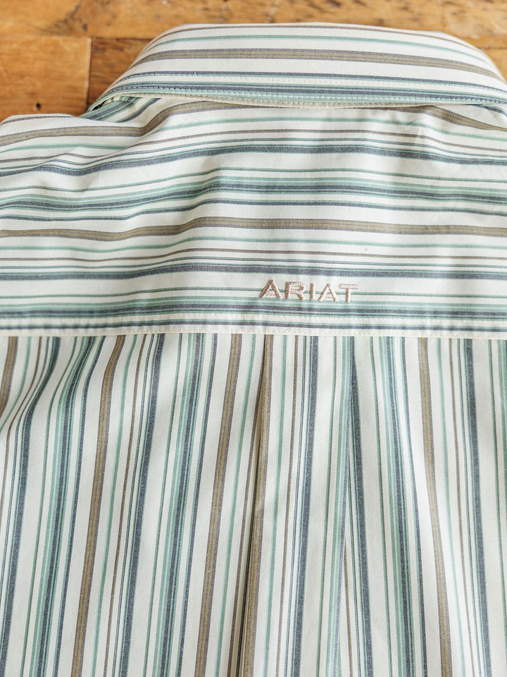 Close-up of the back of The Austwell Men's shirt by Savannah Sevens western life&style in green, blue, and tan stripes, featuring embroidery above the yoke. This short sleeve button-up delivers classic style and sun protection.