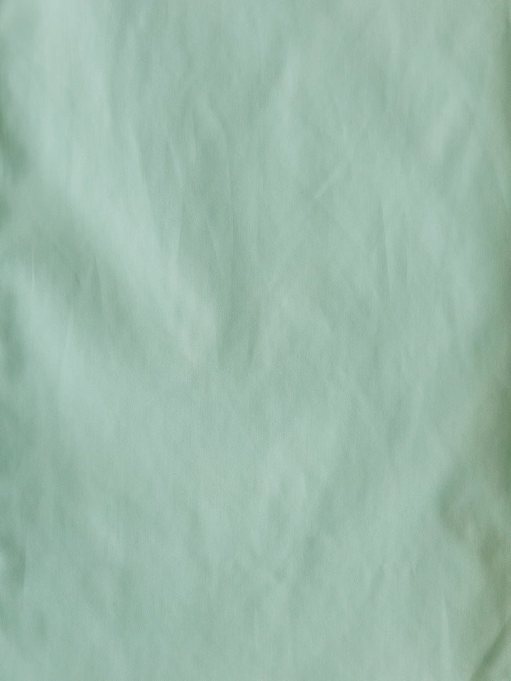 The Williamsburg by Savannah Sevens western life{&}style features light green, slightly wrinkled fabric with soft creases and a smooth texture—ideal for a men's sage or classic fit cotton shirt.
