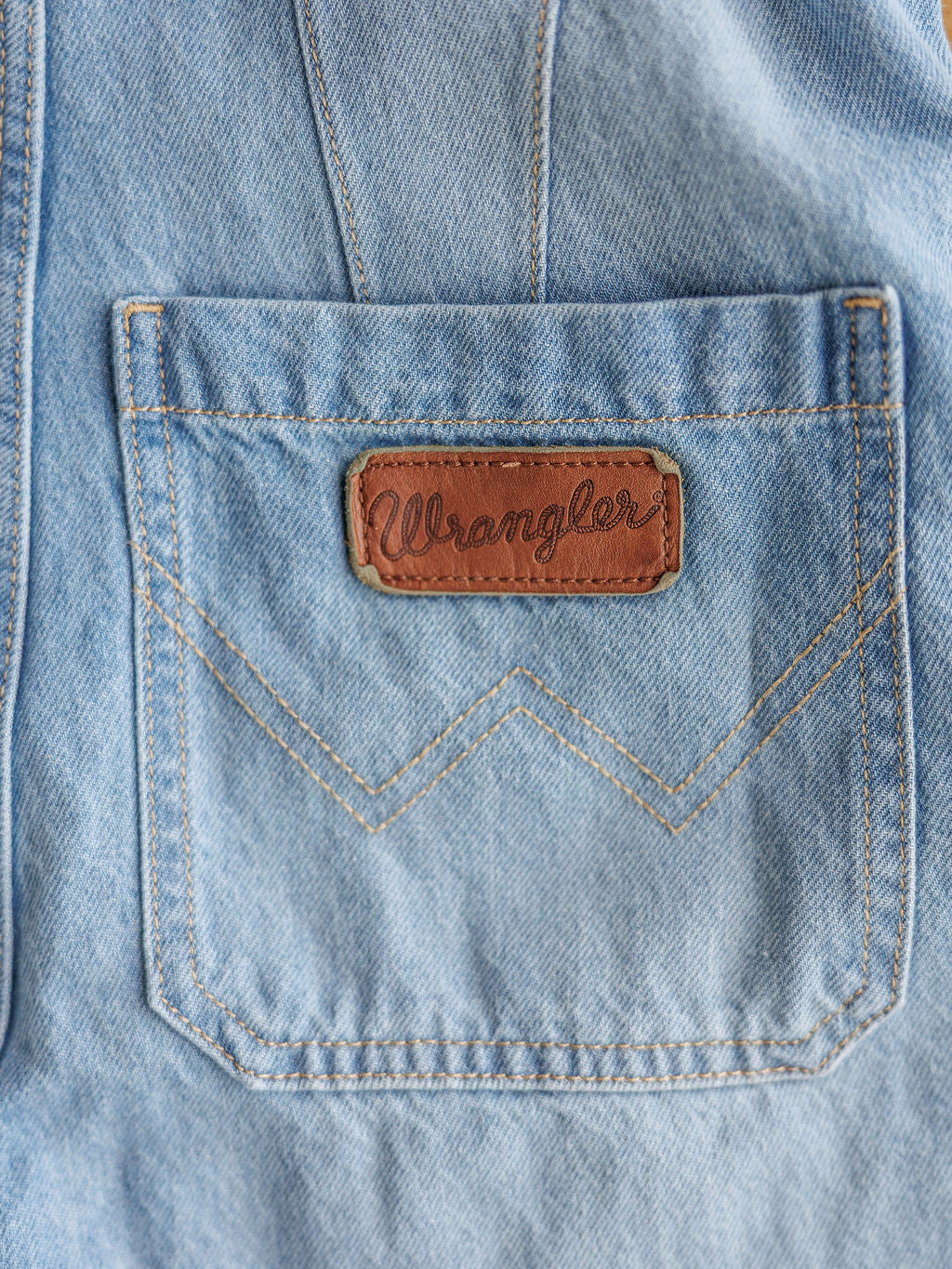 Close-up of The Kennard by Savannah Sevens western life{&}style: medium light wash denim with a brown leather patch above the pocket. Yellowish double V stitching adds unique detail to the classic western design.