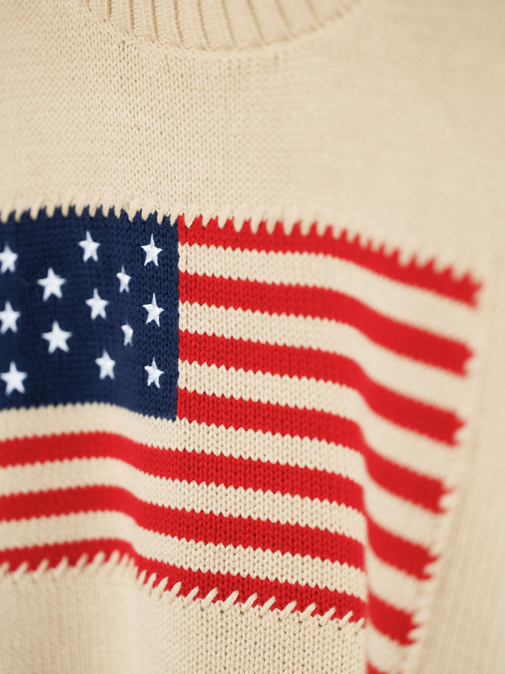Close-up of The Original {Exclusive} sweater by Savannah Sevens western life{&}style, crafted from 100% cotton with red and white stripes and embroidered white stars on a blue rectangle.