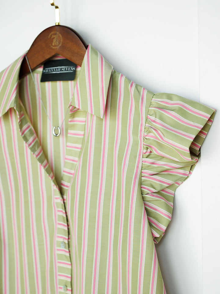 The Rayas by Savannah Sevens western life{&}style: a striped button-up top with green, white, and pink vertical lines, flutter sleeves, and a button-down front, shown on a wooden hanger against a white background.