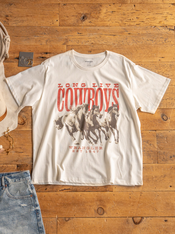 The Long Live by Savannah Sevens western life{&}style is a white oversized tee with a western running horses graphic, bold red "LONG LIVE COWBOYS" text, and "WRANGLER EST. 1947" printed below the artwork.