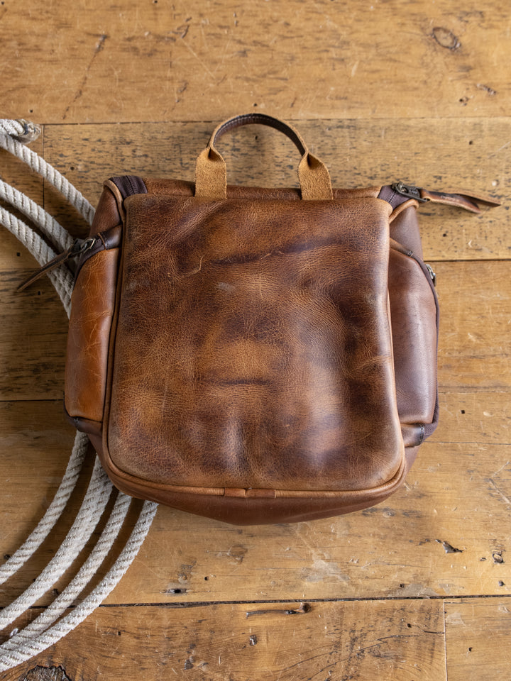 A Waynesboro Shave Kit from Savannah Sevens western life{&}style rests on a wooden surface next to a coiled white rope.