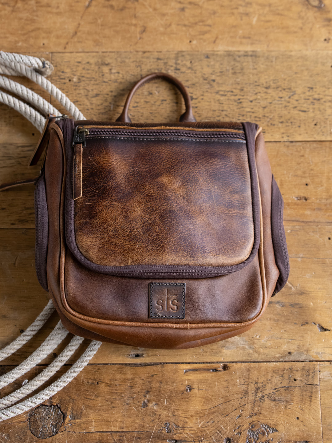 The Waynesboro Shave Kit by Savannah Sevens western life{&}style sits on a rustic wooden surface next to a coiled rope.