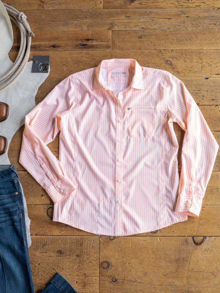 The Lovilia by Savannah Sevens western life{&}style, a striped long sleeve sun shirt in light pink and white, is styled on a wooden floor with blue jeans, a white belt with brown buckles, and a coiled rope.