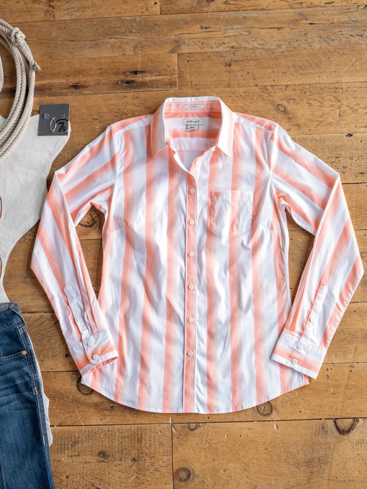 The Forada by Savannah Sevens western life{&}style, a vertical pink and white striped button-up top, is displayed on a wooden floor beside blue jeans and a coiled rope.