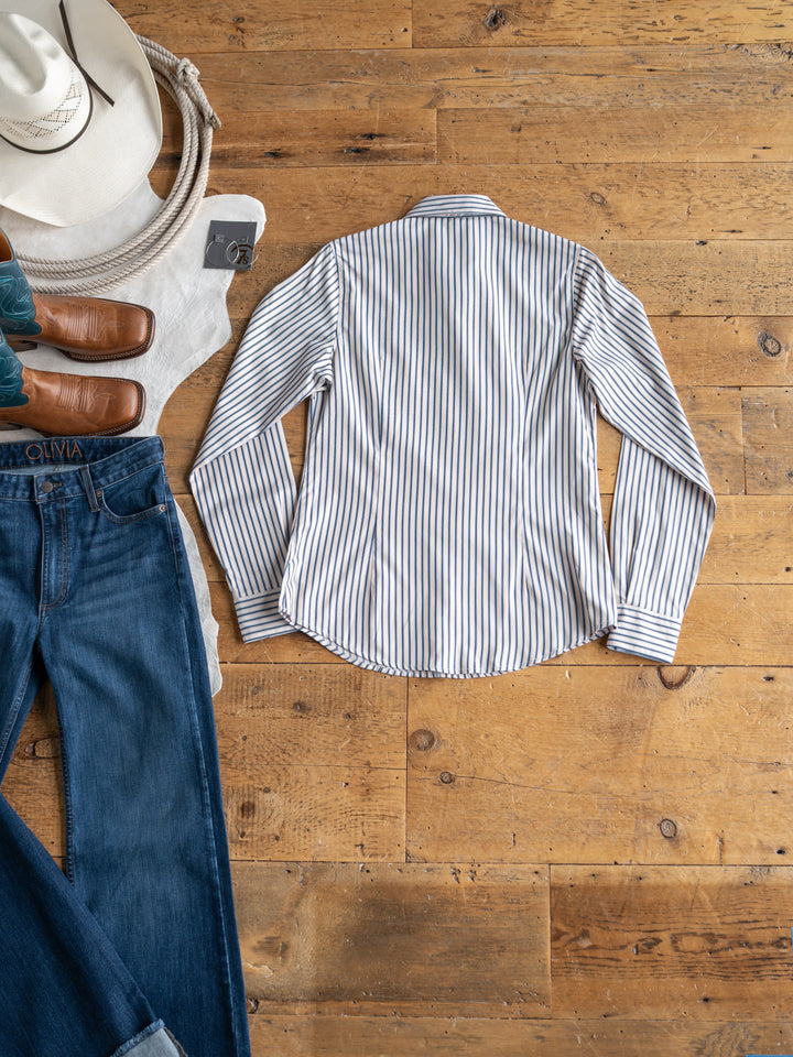 The Durant {S-XXL} tencel top from Savannah Sevens western life{&}style is styled flat with blue jeans, brown leather boots, a white cowboy hat, and a white sweater on a wooden floor.