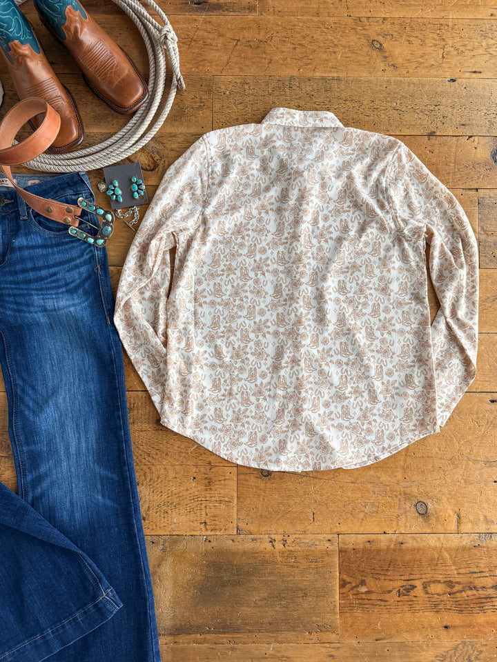 The Nekoma {S-XXL} by Savannah Sevens western life{&}style is a cream paisley long sleeve button up, styled with blue jeans, brown cowboy boots, a leather belt, turquoise jewelry, and a brown cowboy hat for a classic Western look.