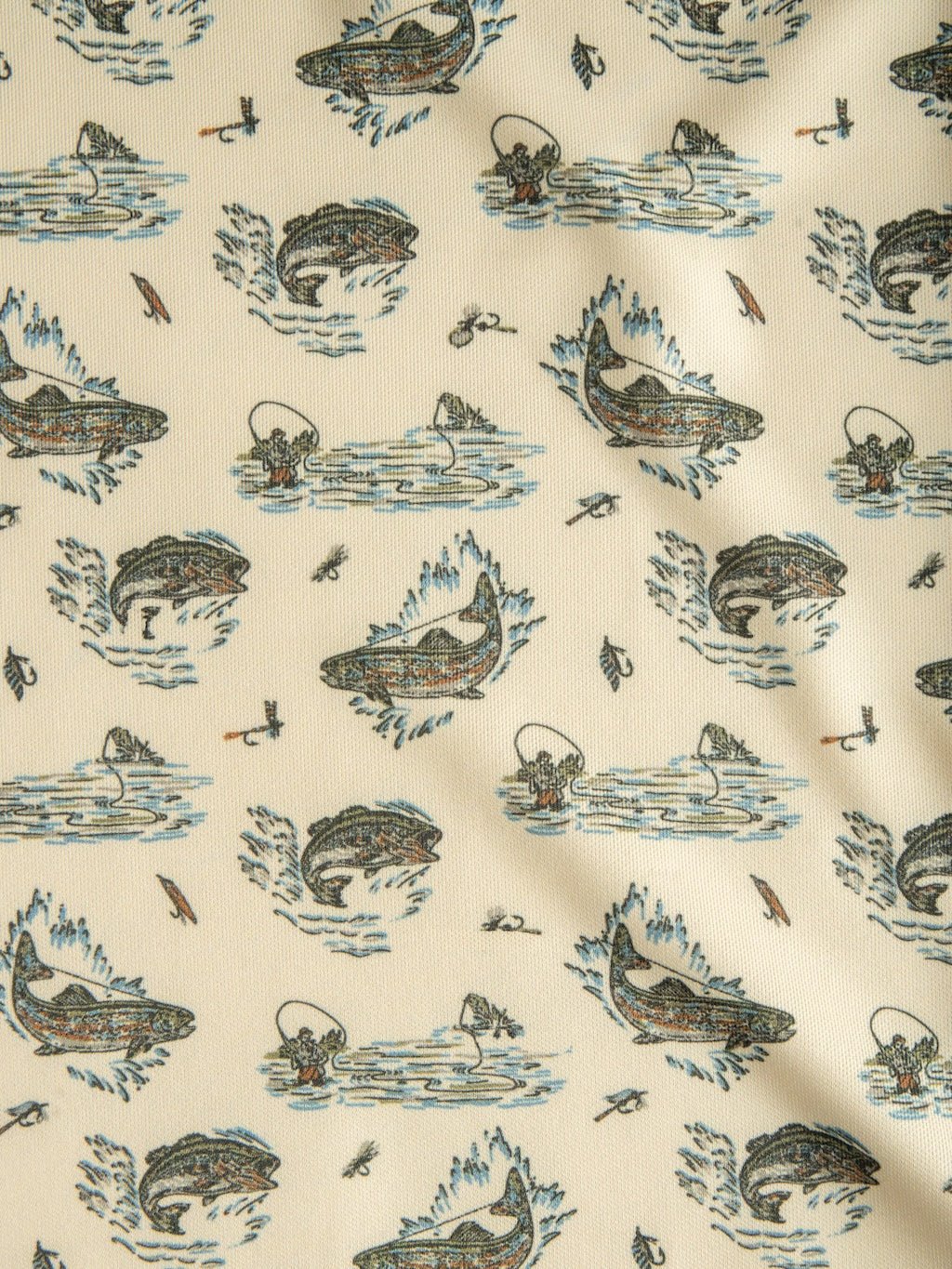 Crafted by Savannah Sevens western life{&}style, the Big Bass Cinch Men's Graphic Polo features beige fabric adorned with a repeating pattern of illustrated fish leaping from water, fishing flies, nets, and gentle ripples in understated blue, green, brown, and black hues. The fabric has a slightly wrinkled appearance and is ideal for moisture-wicking bass fishing shirts or ArenaFlex polos.