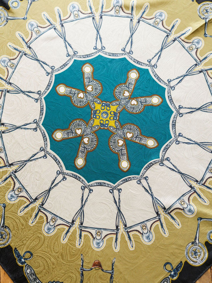 The Bits Wild Rag {Teal} by Savannah Sevens western life{&}style is a vibrant jacquard silk scarf with scissors and ornate keys in a kaleidoscopic paisley design, featuring teal, white, and gold for a luxurious statement.