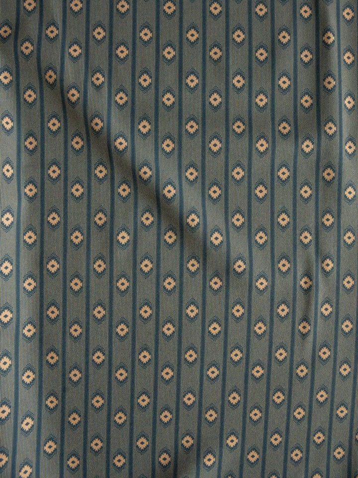 A blue-green fabric with a vertical stripe pattern of small beige floral motifs, subtly wrinkled and shaded as if gently draped—echoing the classic style of the Brigham Wrangler Men's Southwest Button Up by Savannah Sevens western life{&}style.