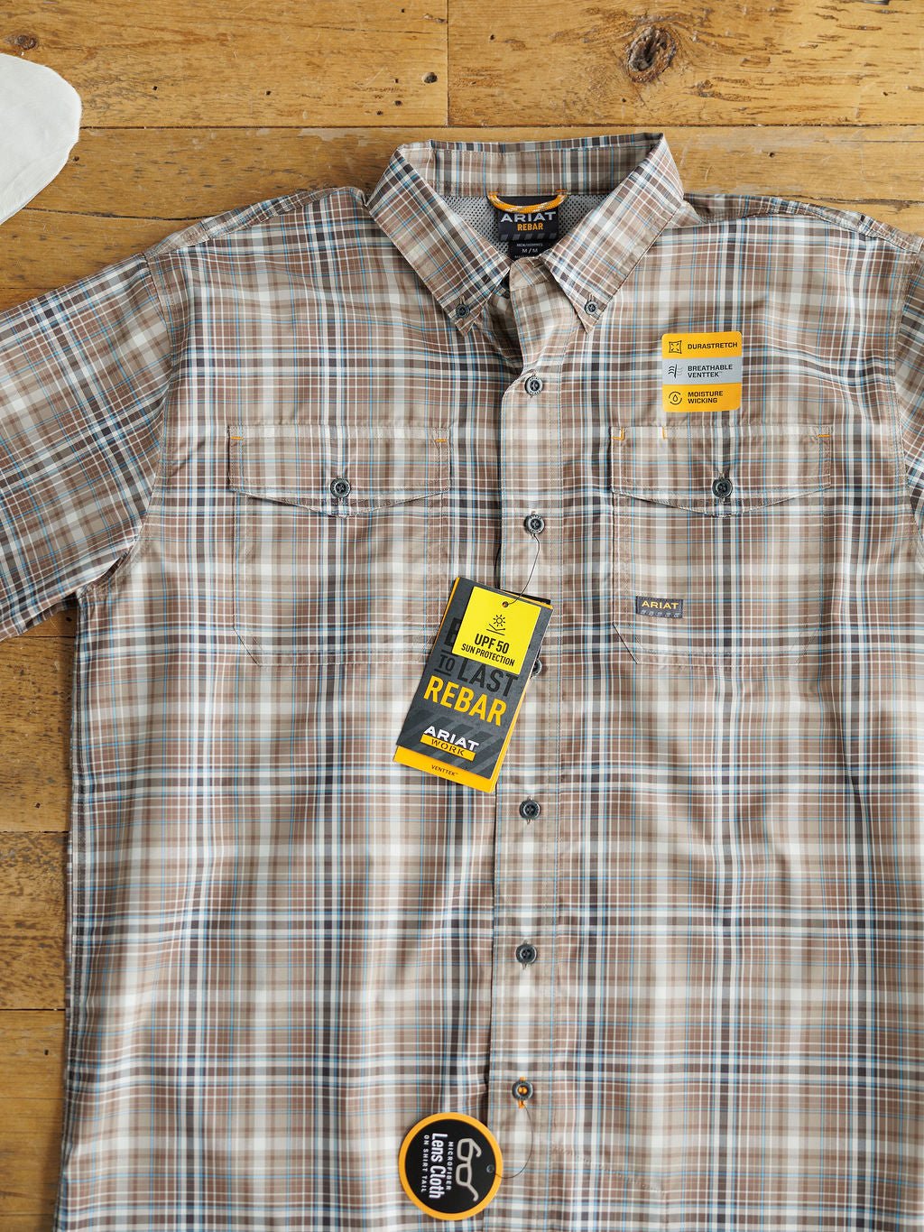 The Brimson Ariat Men's Plaid Button Up from Savannah Sevens western life{&}style offers UPF 50+, ToughMax durability, and advanced moisture wicking for all-day comfort and performance. Laid flat with tags attached.