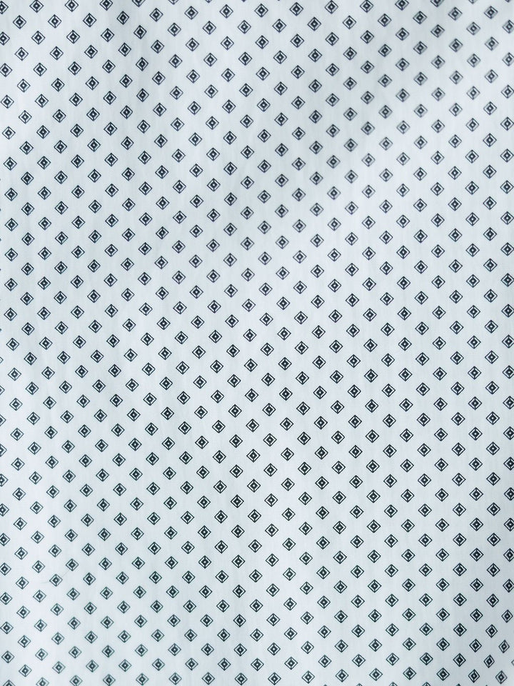 The Burke Ariat Men's Southwest Pearl Snap from Savannah Sevens western life{&}style features white fabric with a repeating small black diamond pattern, perfect for a classic, stylish men's snap button shirt.