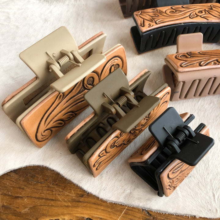 Five Campitos Claw Clips featuring tan, floral-tooled leather accents on heavy-duty beige, olive, and black plastic clips.
