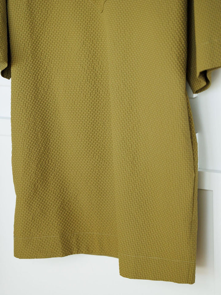 The Chino Valley Olive Textured Dress by Savannah Sevens western life{&}style features a close-up of its waffle-like pattern and short sleeves, displayed against a white background.