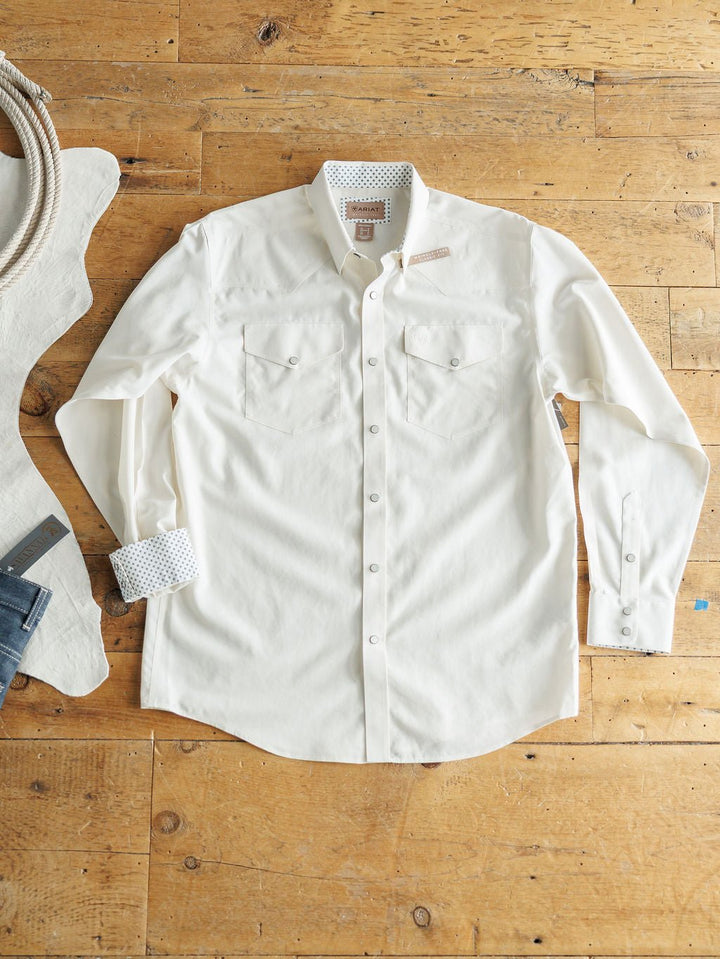 The Collinsville Ariat Men's Natural Pearl Snap shirt by Savannah Sevens western life{&}style, wrinkle-free cotton in off-white, features two chest pockets and patterned inner cuffs, shown flat beside denim jeans and a coiled rope.