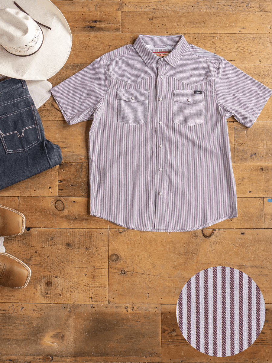 Flat lay of the Cutler Cinch Men's Pinstripe Pearl Snap by Savannah Sevens western life{&}style, folded blue jeans, a white cowboy hat, and brown cowboy boots on a wooden floor. Inset shows the shirt’s red and white stripe pattern.