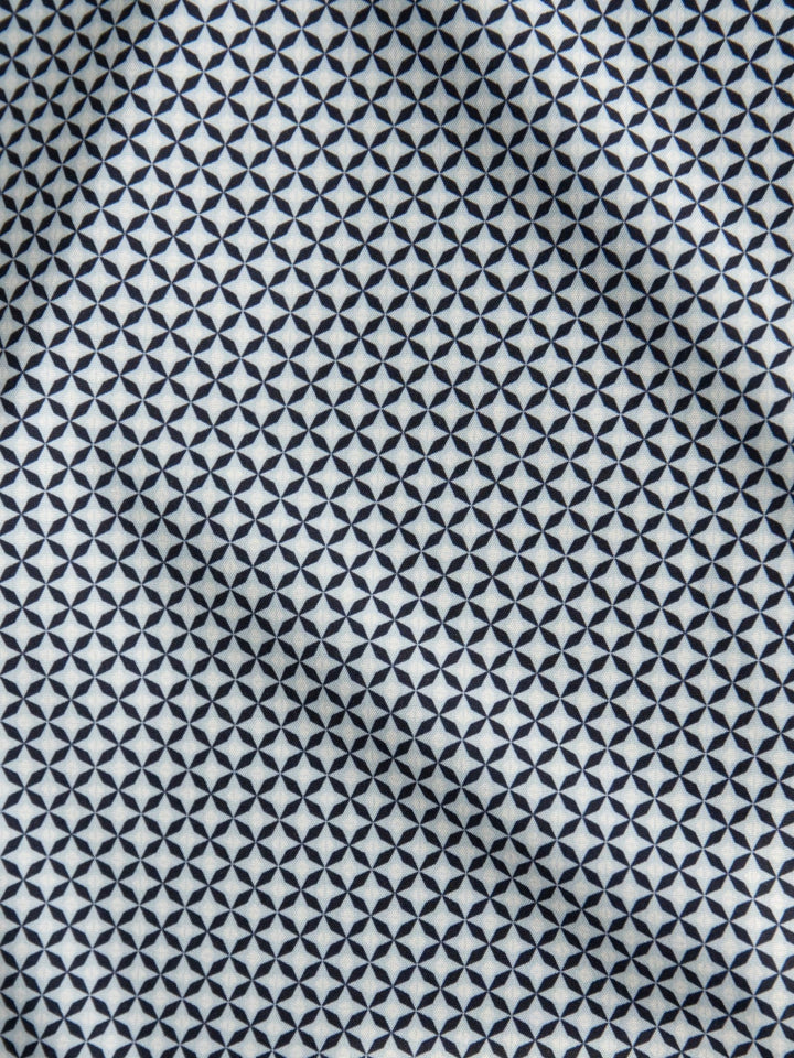 The Dade Cinch Men's Navy Southwest Button Up by Savannah Sevens western life{&}style features a geometric black diamond and star pattern on white fabric, adding dimension and style, perfect for UV-protected southwest shirts.