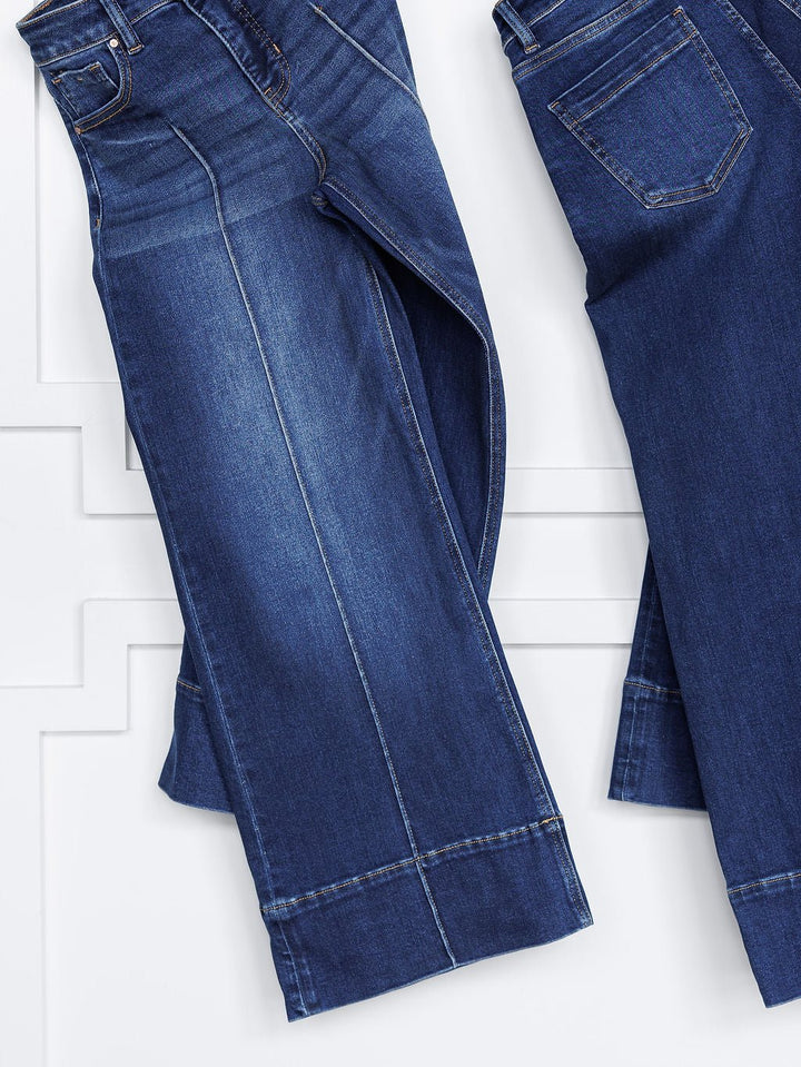 Two pairs of The Dakota High Rise Wide Leg Crop Jeans by Savannah Sevens western life{&}style in blue denim are laid flat on a white surface, showing the front and back with visible stitching, pockets, tummy control, faded details, and wide cropped legs.