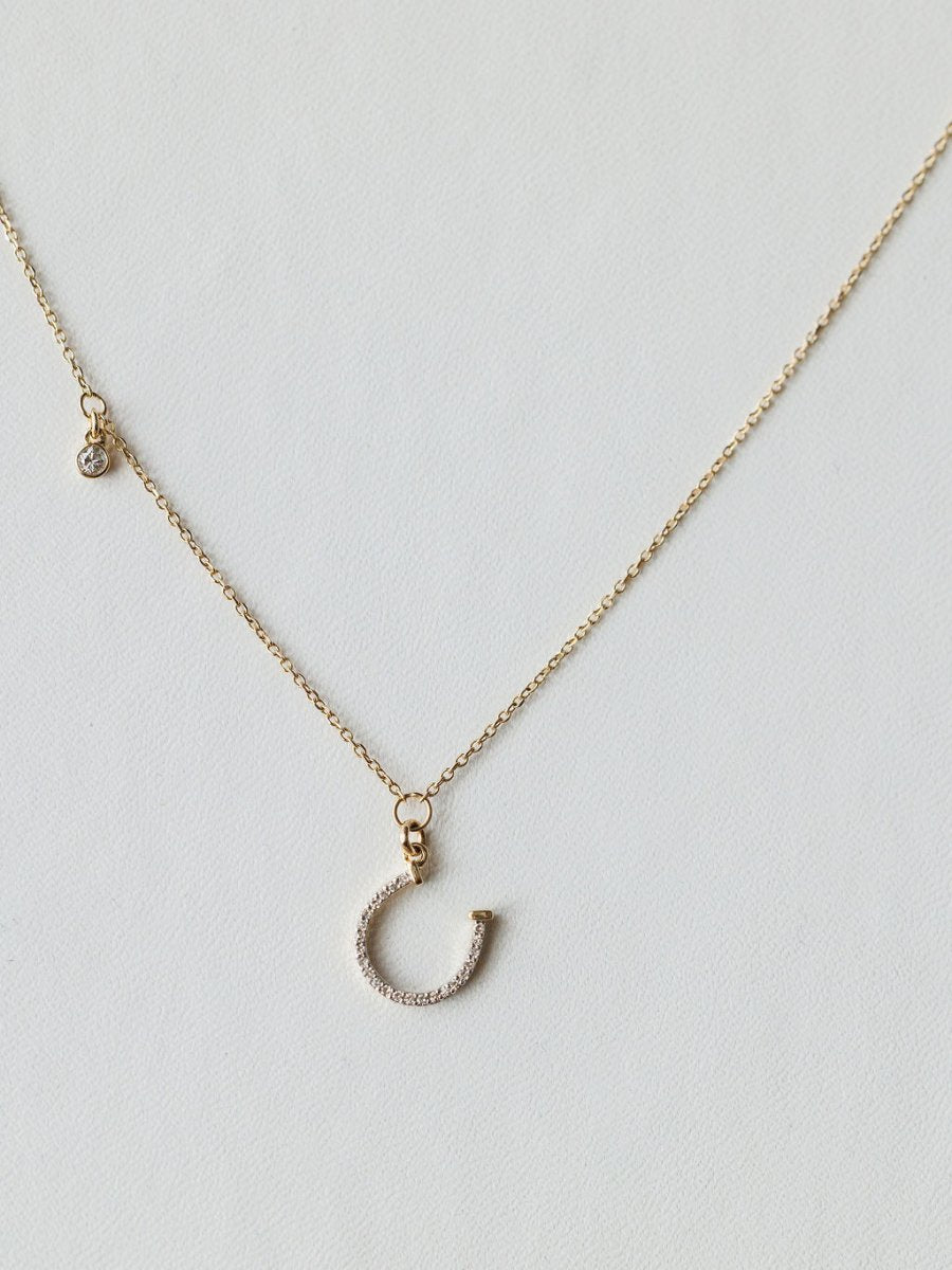 The Savannah Sevens western life{&}style Diamond Horseshoe Necklace features a sparkling horseshoe pendant on a fine chain, displayed against a light background.