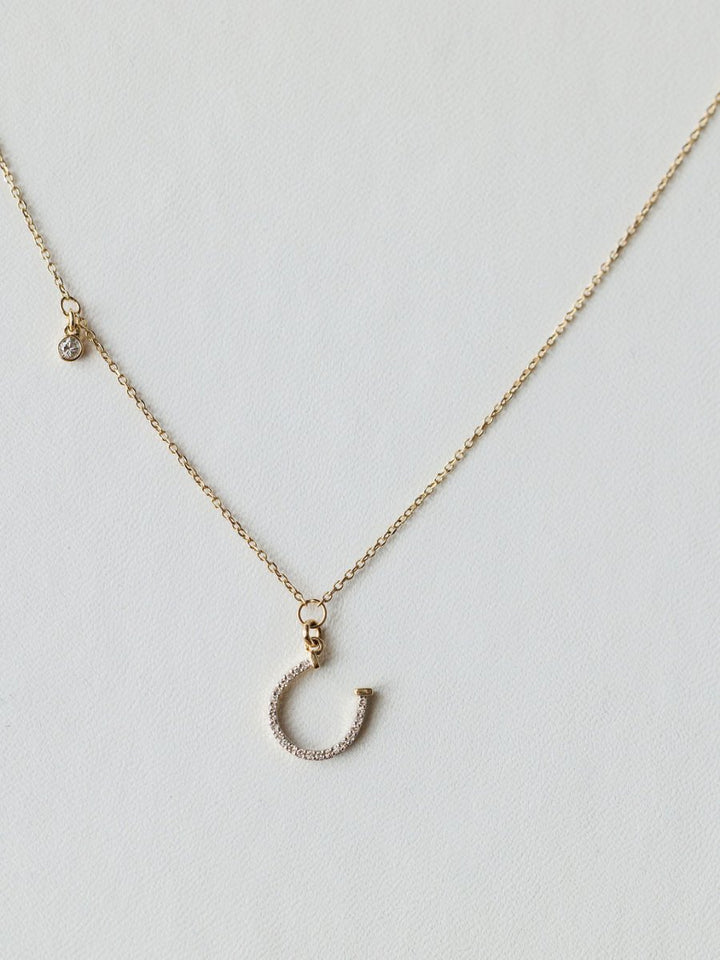 The Savannah Sevens western life{&}style Diamond Horseshoe Necklace features a sparkling horseshoe pendant on a fine chain, displayed against a light background.