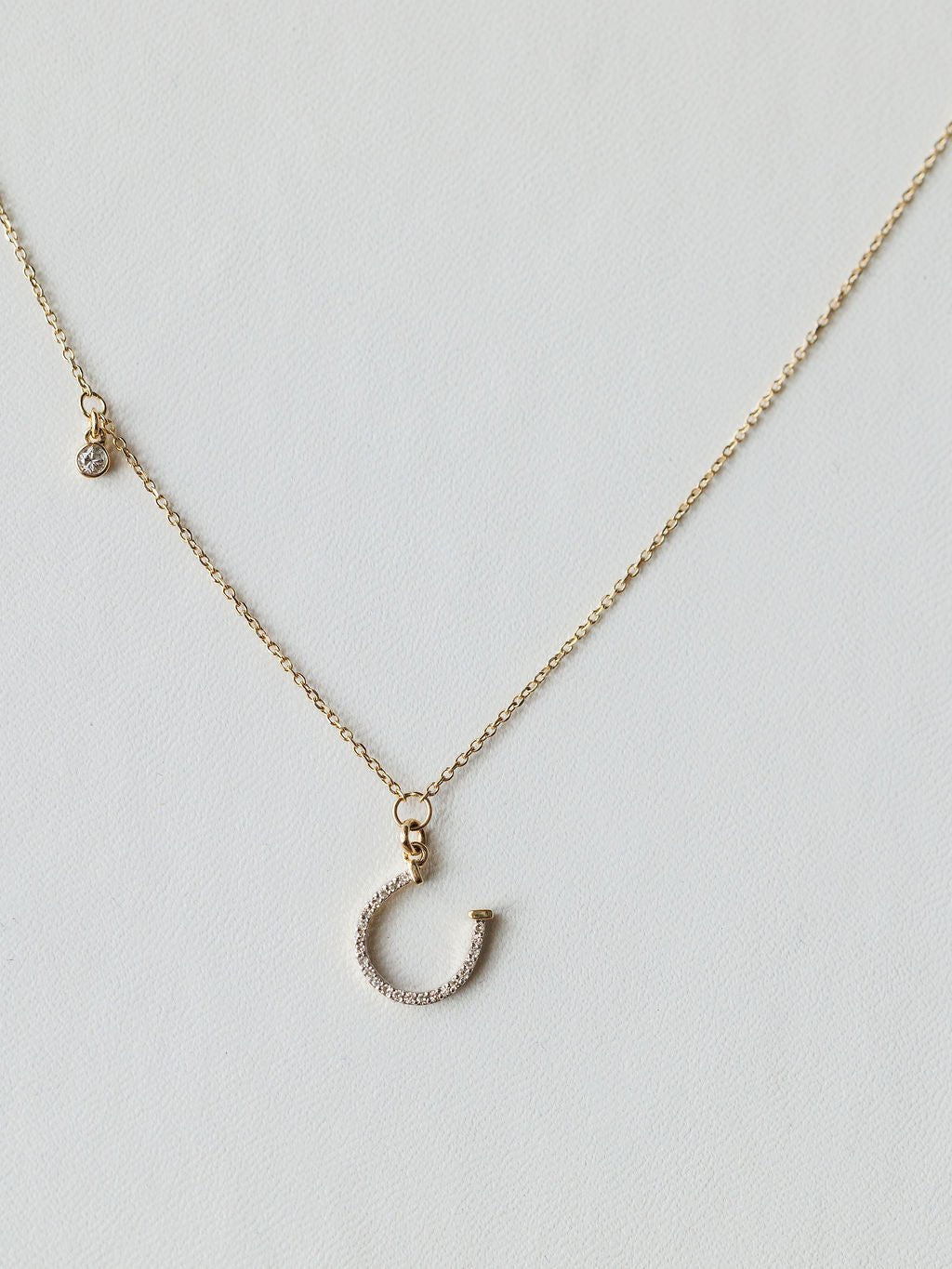 The Savannah Sevens western life{&}style Diamond Horseshoe Necklace features a sparkling horseshoe pendant on a fine chain, displayed against a light background.
