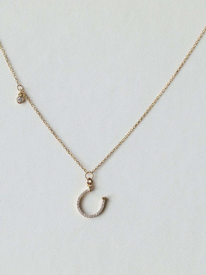 The Savannah Sevens western life{&}style Diamond Horseshoe Necklace features a sparkling horseshoe pendant on a fine chain, displayed against a light background.