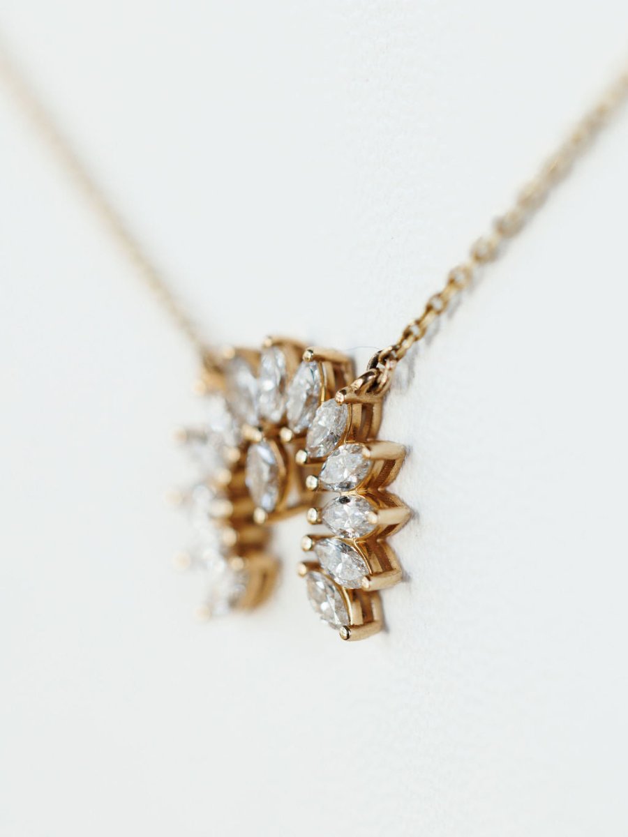 Close-up of the Diamond Naja Necklace by Savannah Sevens western life{&}style, showcasing a naja pendant with marquise-cut lab grown diamonds on a delicate 14K gold chain, set against a soft white background.
