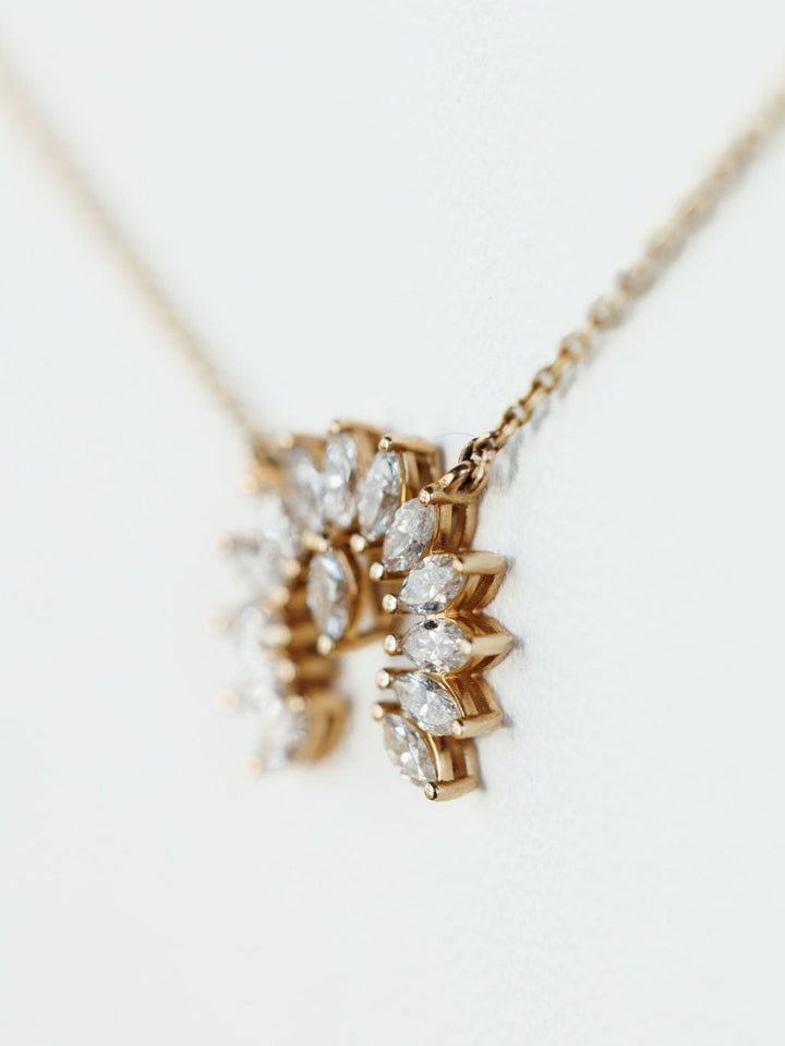 Close-up of the Diamond Naja Necklace by Savannah Sevens western life{&}style, showcasing a naja pendant with marquise-cut lab grown diamonds on a delicate 14K gold chain, set against a soft white background.