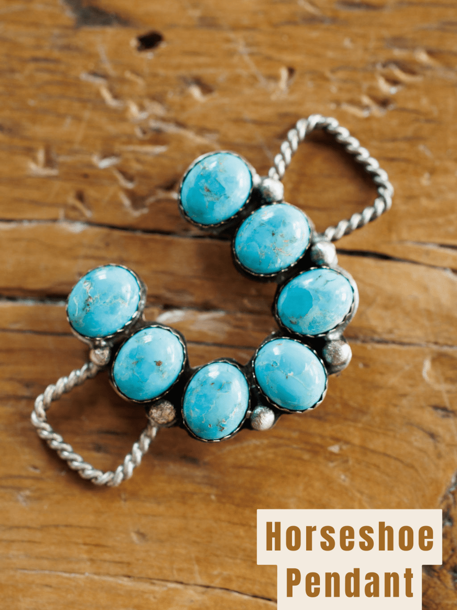 The Etowah Scarf Pendant by Savannah Sevens western life{&}style features seven Kingman turquoise stones set in a sterling silver horseshoe, displayed on rustic wood. "Horseshoe Pendant" is noted in the corner.
