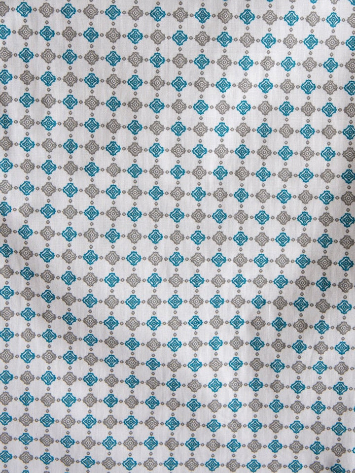 White fabric featuring a repeating geometric pattern of small blue and gray diamond shapes, arranged in evenly spaced rows and columns—ideal for the Georgetown Wrangler Men's Southwest Button Up by Savannah Sevens western life{&}style.
