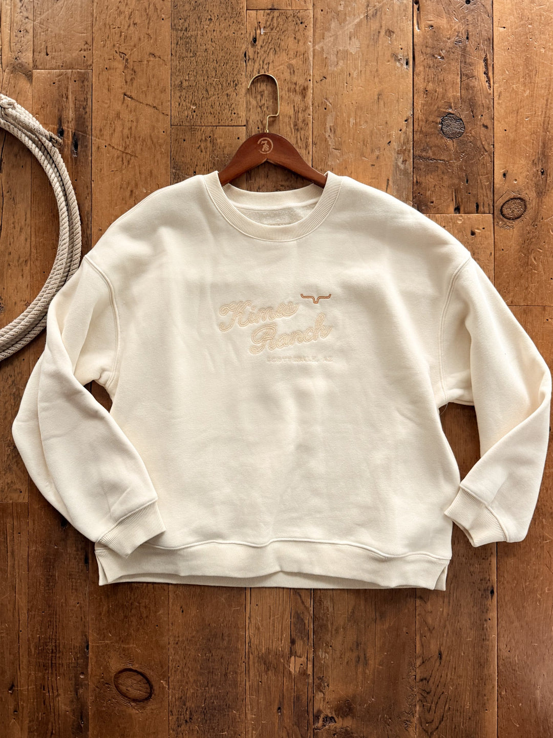 Savannah Sevens western life&style Glendale Cream Embroidered Pullover in a cream oversized relaxed fit crewneck style with tan embroidered text that reads Himes Ranch, Scottsdale, AZ and a steer skull icon.