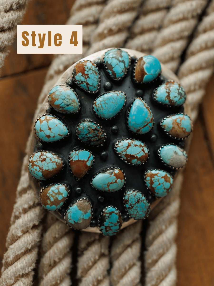 The Las Cruces Buckle by Savannah Sevens western life{&}style features teardrop-shaped brown and Number 8 Turquoise stones set in silver on a black background, resting on coiled rope. A Style 4 label appears in the top left corner.