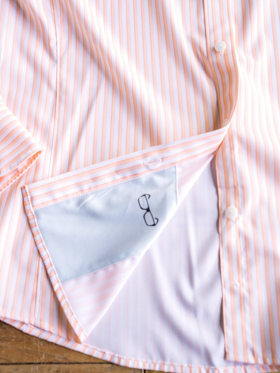 A close-up of The Lovilia by Savannah Sevens western life{&}style, a striped long sleeve button-down shirt with a triangular inner pocket featuring a small eyeglasses print on light blue lining.