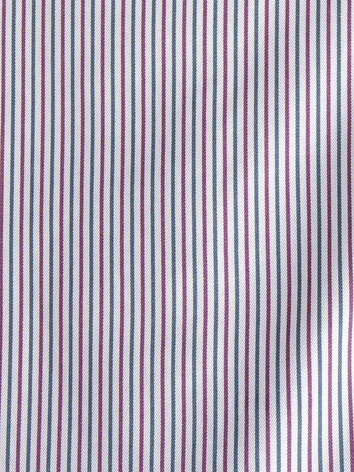 Close-up of the Newburg Striped Tencel Performance Shirt by Savannah Sevens western life{&}style, showcasing evenly spaced vertical stripes in purple, blue, and white. The fabric appears smooth with a slight wrinkle on the right side.