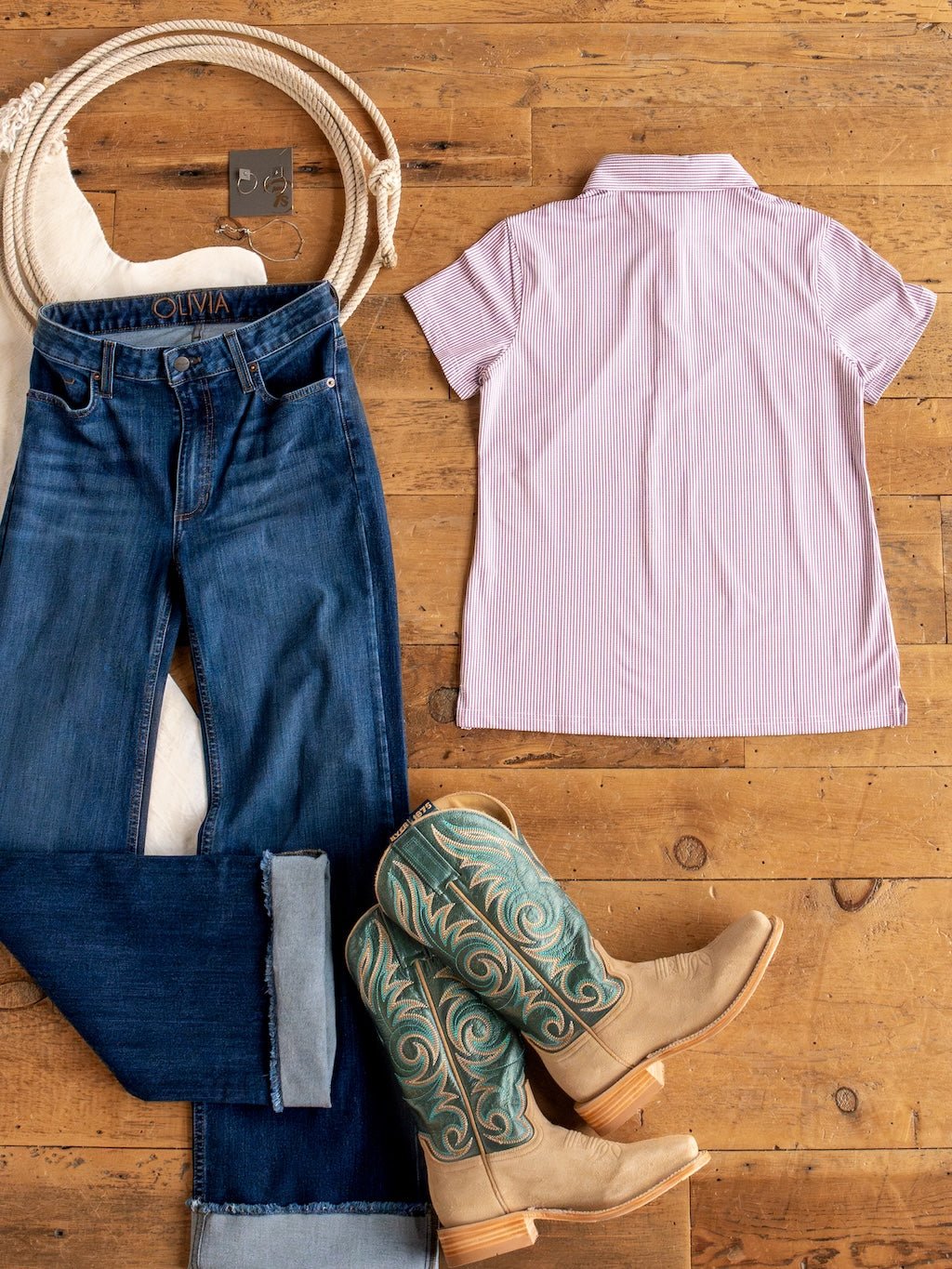 Flat lay of the Payden Burgundy Striped Polo by Savannah Sevens western life{&}style displayed on a wooden floor.