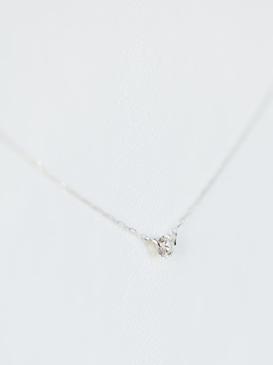 The Petite Diamond Necklace {White Gold} by Savannah Sevens western life{&}style features a single natural round diamond pendant in 18K white gold, displayed against a white background.