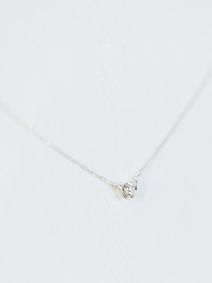 The Petite Diamond Necklace {White Gold} by Savannah Sevens western life{&}style features a single natural round diamond pendant in 18K white gold, displayed against a white background.