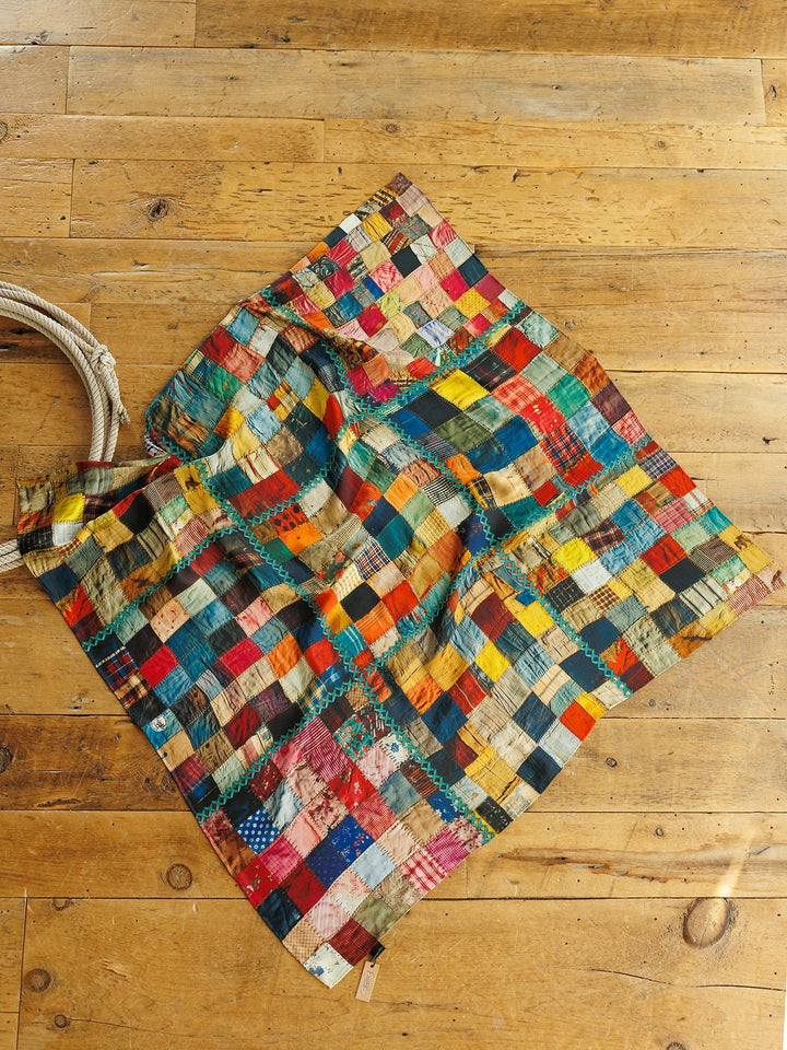 Savannah Sevens western life&style Quilt Silk Scarf featuring a square, multicolored patchwork design joined by visible teal zigzag stitching.