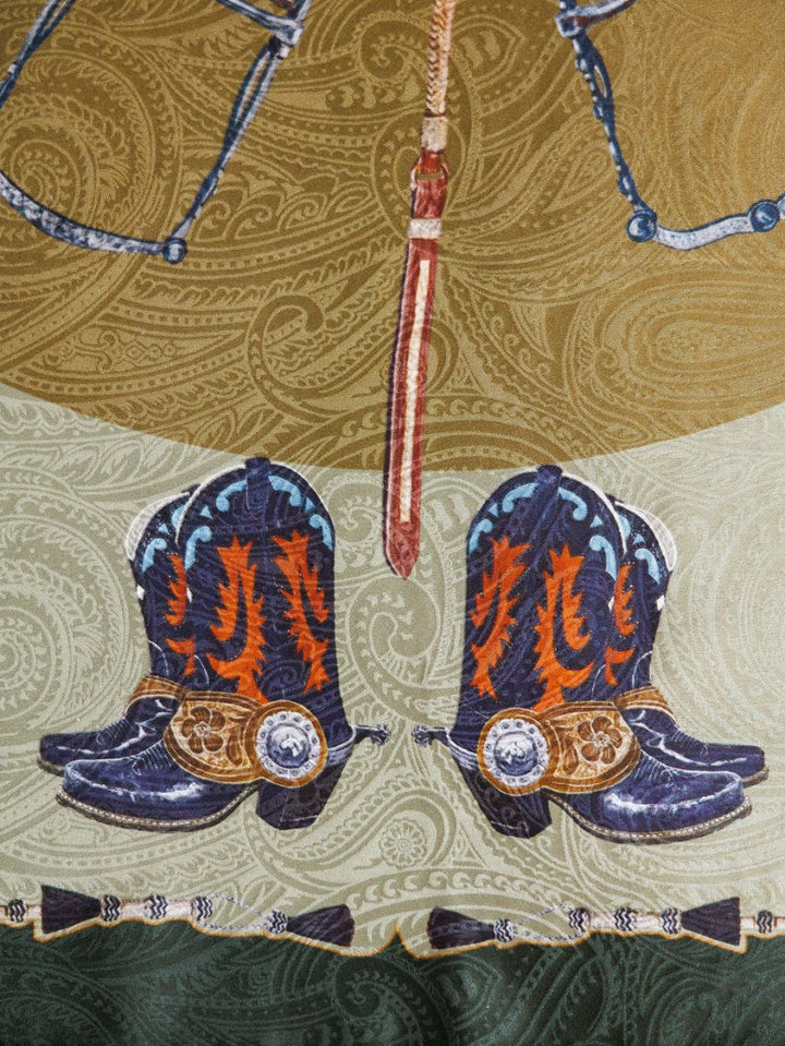 Illustration of decorated cowboy boots with spurs and an ornate belt above, set on a green and brown paisley backdrop, inspired by the luxury Ranch Gear Wild Rag from Savannah Sevens western life{&}style.