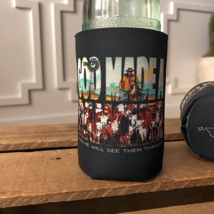 The Rancher Koozie by Savannah Sevens western life{&}style features hand-drawn cowboy and cattle art with bold "GOD MADE A" and "AND HE WILL SEE THEM THROUGH" text. Proceeds support Samaritan's Purse donation efforts.