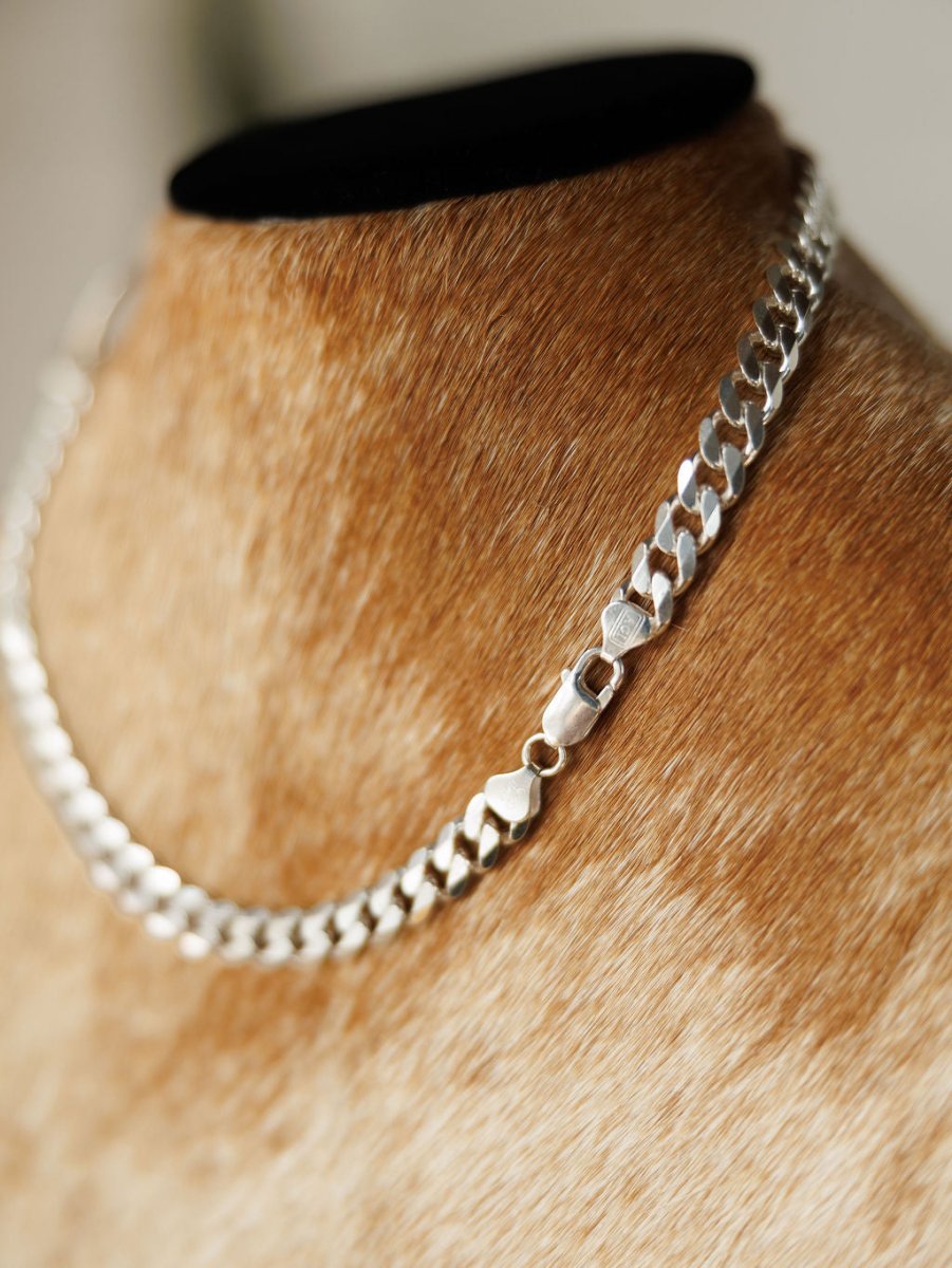 The Ranchero Necklace by Savannah Sevens western life{&}style, a sterling silver snaffle bit design, is shown close-up on a tan fur-covered mannequin bust with a black top.