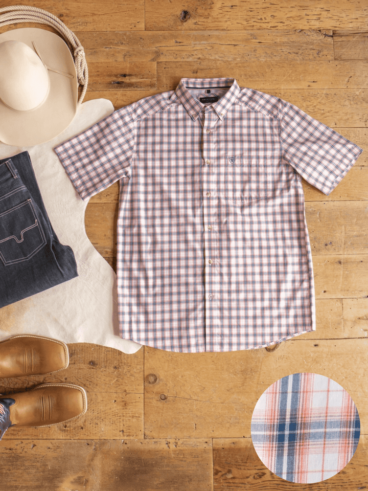 Raymore Ariat Men's Plaid Button Up from Savannah Sevens western life{&}style is displayed on a wood floor with jeans, a cowboy hat, and brown boots; fabric detail shown in the corner.